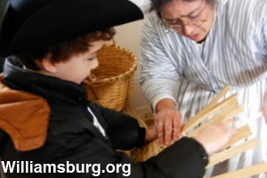 A young boy learns how to weave a basket.