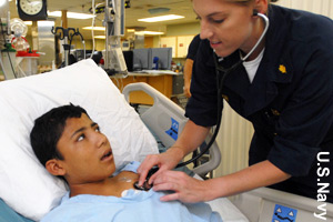 A nurse checking a patient's heart