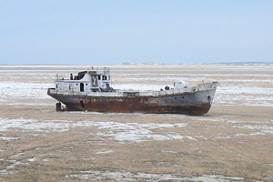 A boat sits where there was once water.